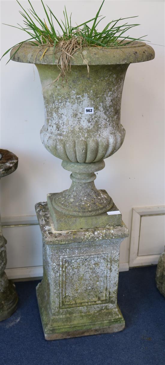 A Grecian style reconstituted stone garden urn, on plinth W.53cm